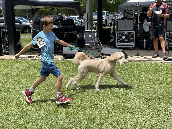 Boy and his dog participating in the Creek Bark Dog Pageant at Leeds Creek Bank Festival Leeds Alabama